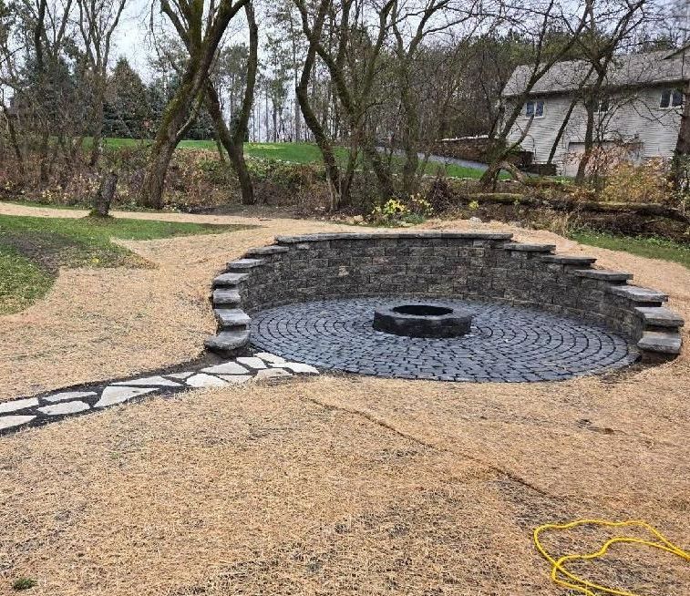 After: stone fire pit with seating area in a gravel yard