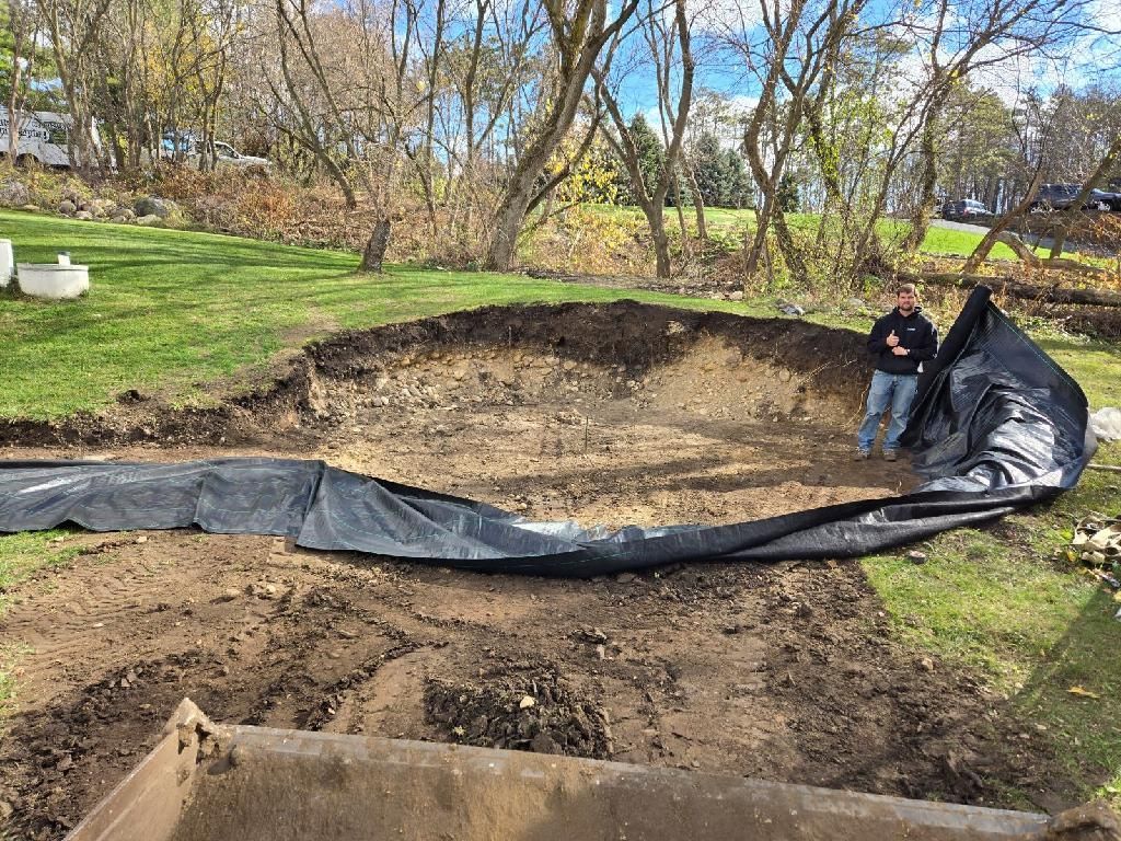 Before: excavated yard with pond liner partially covering the dirt