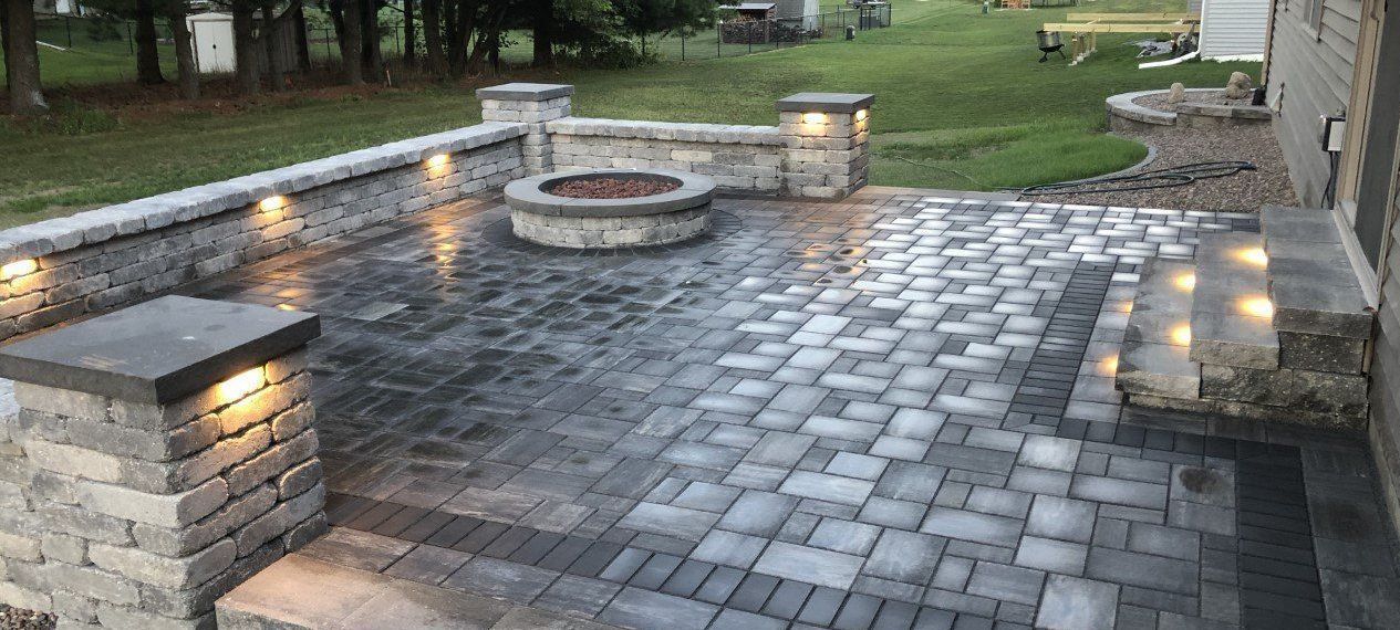 Flagstone walkway winding through landscaped garden beds beside a home